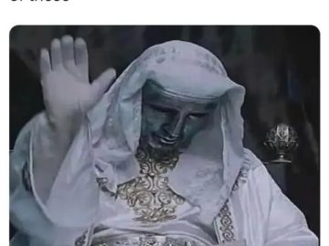 Statue raising hand like blessing a car letting you cross