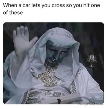 Statue raising hand like blessing a car letting you cross