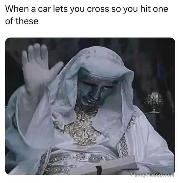Statue raising hand like blessing a car letting you cross