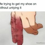Hand struggling to put on shoe without untying it