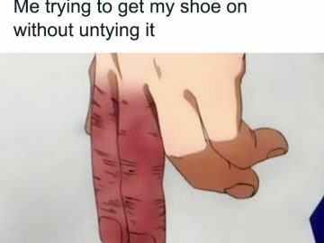 Hand struggling to put on shoe without untying it