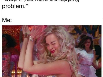 Woman clapping with a wink, embracing her shopping addiction.