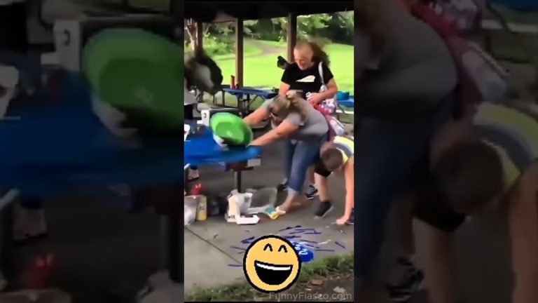 Outdoor party scene with a woman at a picnic table reacting as a green object flies toward her during a fail compilation.