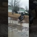 Mini bike rider losing control while attempting a muddy puddle stunt in a funny fail compilation.