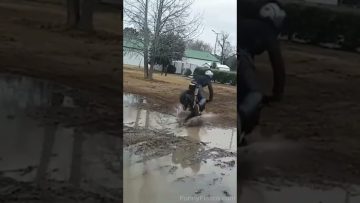 Mini bike rider losing control while attempting a muddy puddle stunt in a funny fail compilation.