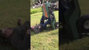 Man loses his balance while trying to cross a narrow ditch and falls into the water.