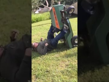 Man loses his balance while trying to cross a narrow ditch and falls into the water.