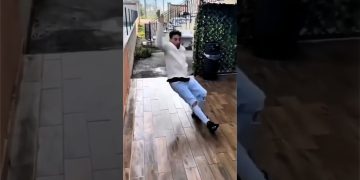 Person losing balance on a small bathroom ladder before outdoor water and street fails follow