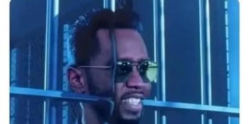 Meme of Diddy slipping between bars in a jail cell humorously.