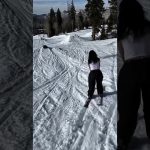 A skier loses balance while sliding a green rail during a snowy wipeout in a funny fails compilation.