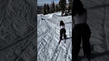 A skier loses balance while sliding a green rail during a snowy wipeout in a funny fails compilation.