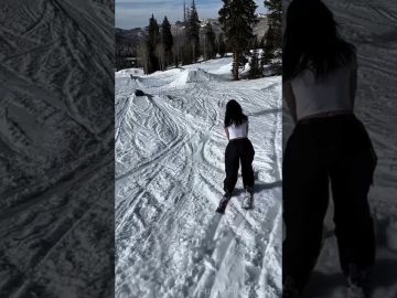 A skier loses balance while sliding a green rail during a snowy wipeout in a funny fails compilation.
